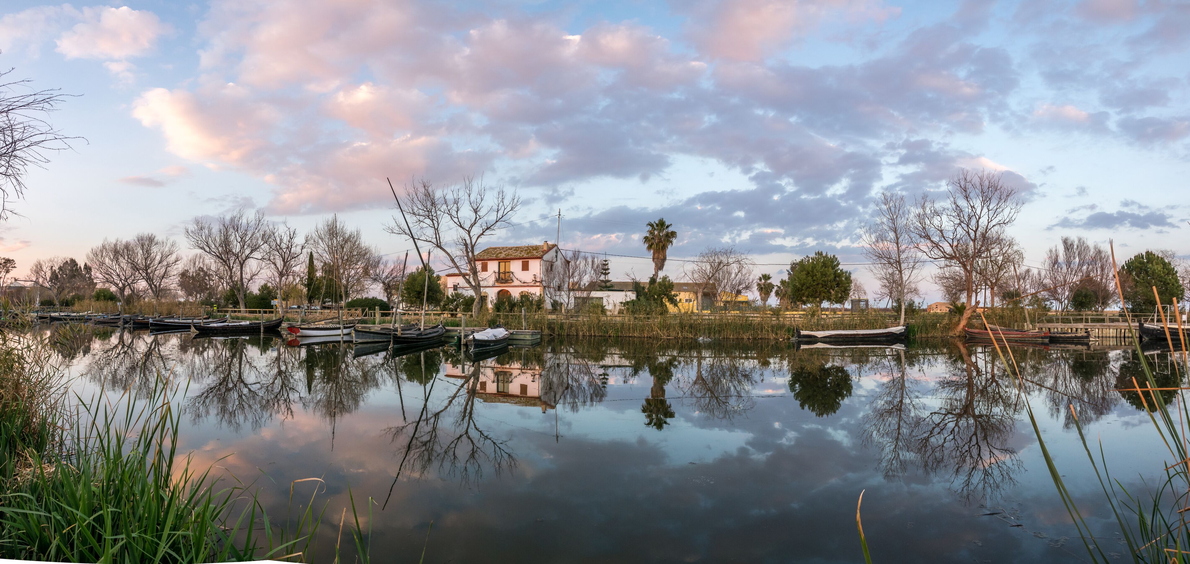Albufera nature reserve in Catarroja Valencia Spain gigapan harbor of the main irrigation ditch that floods the rice fields old traditional wooden boats. Latin sailing ships