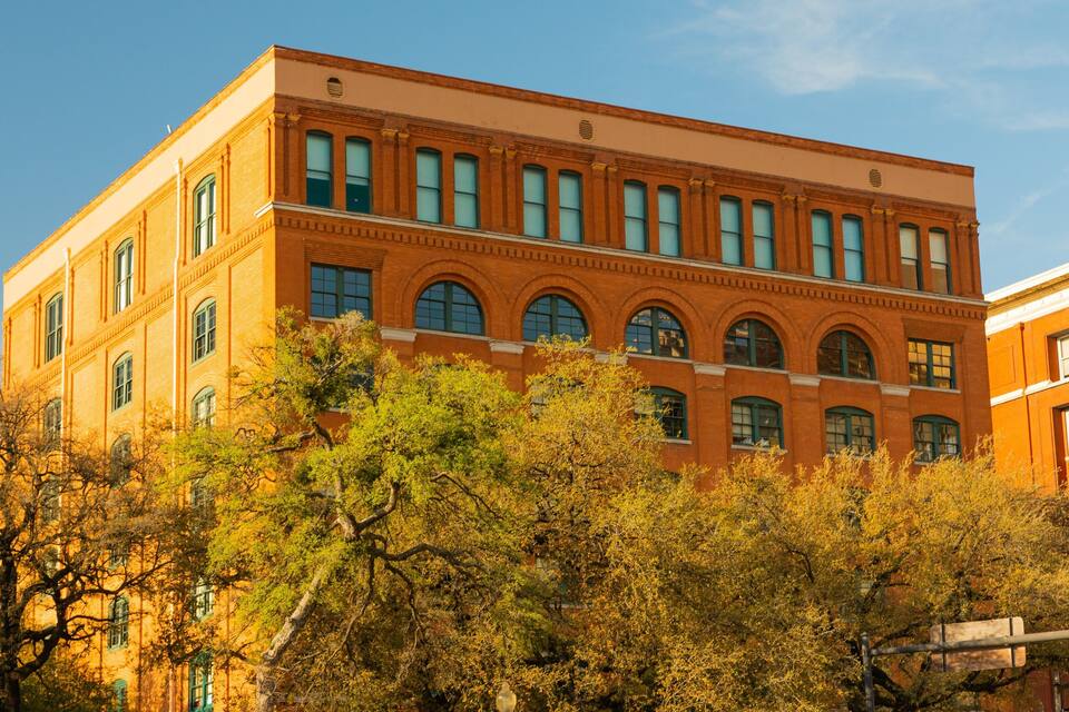 A red brick building with arched windows and a flat roof.