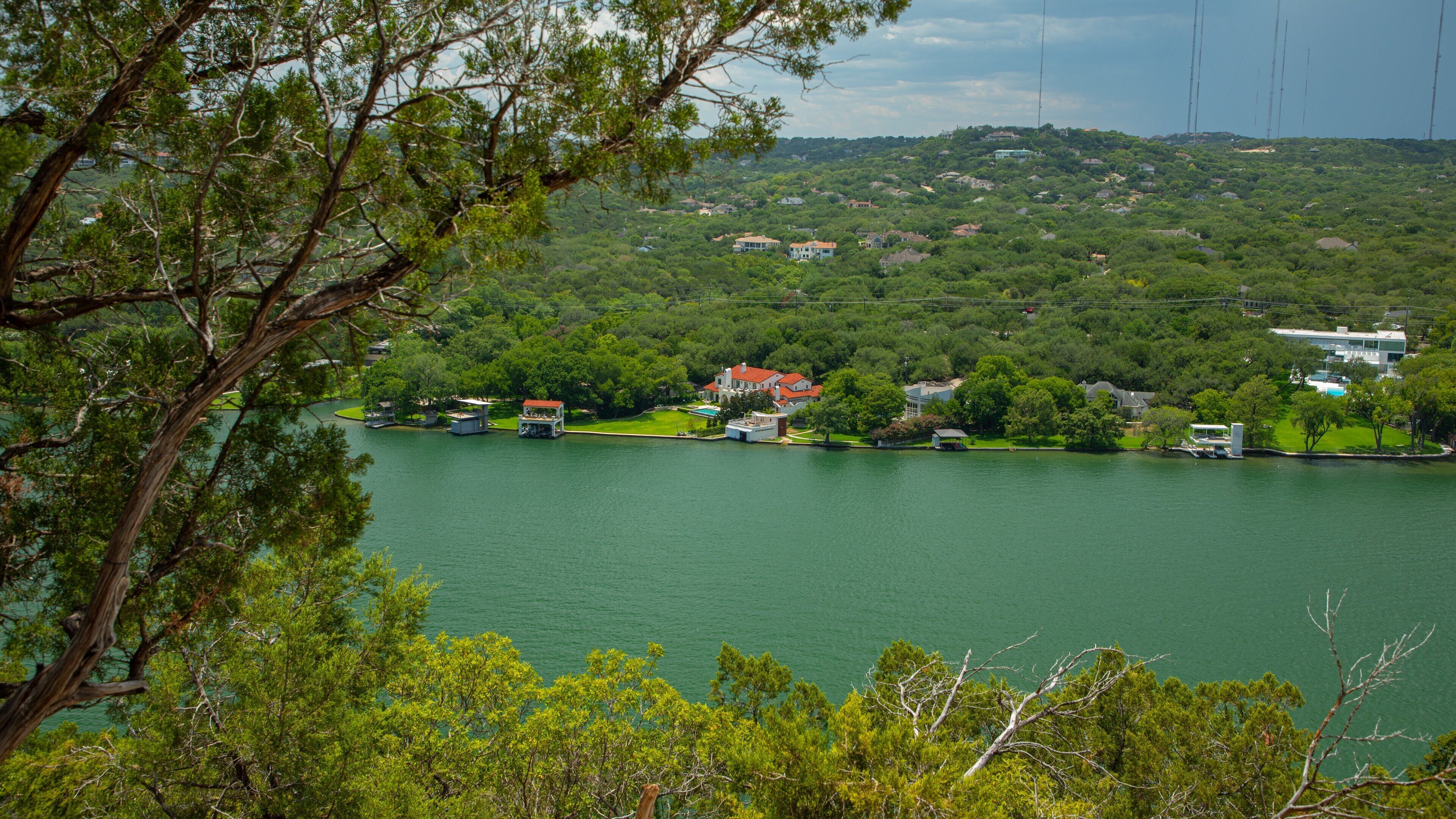 Mount Bonnell which includes landscape views, a river or creek and a small town or village