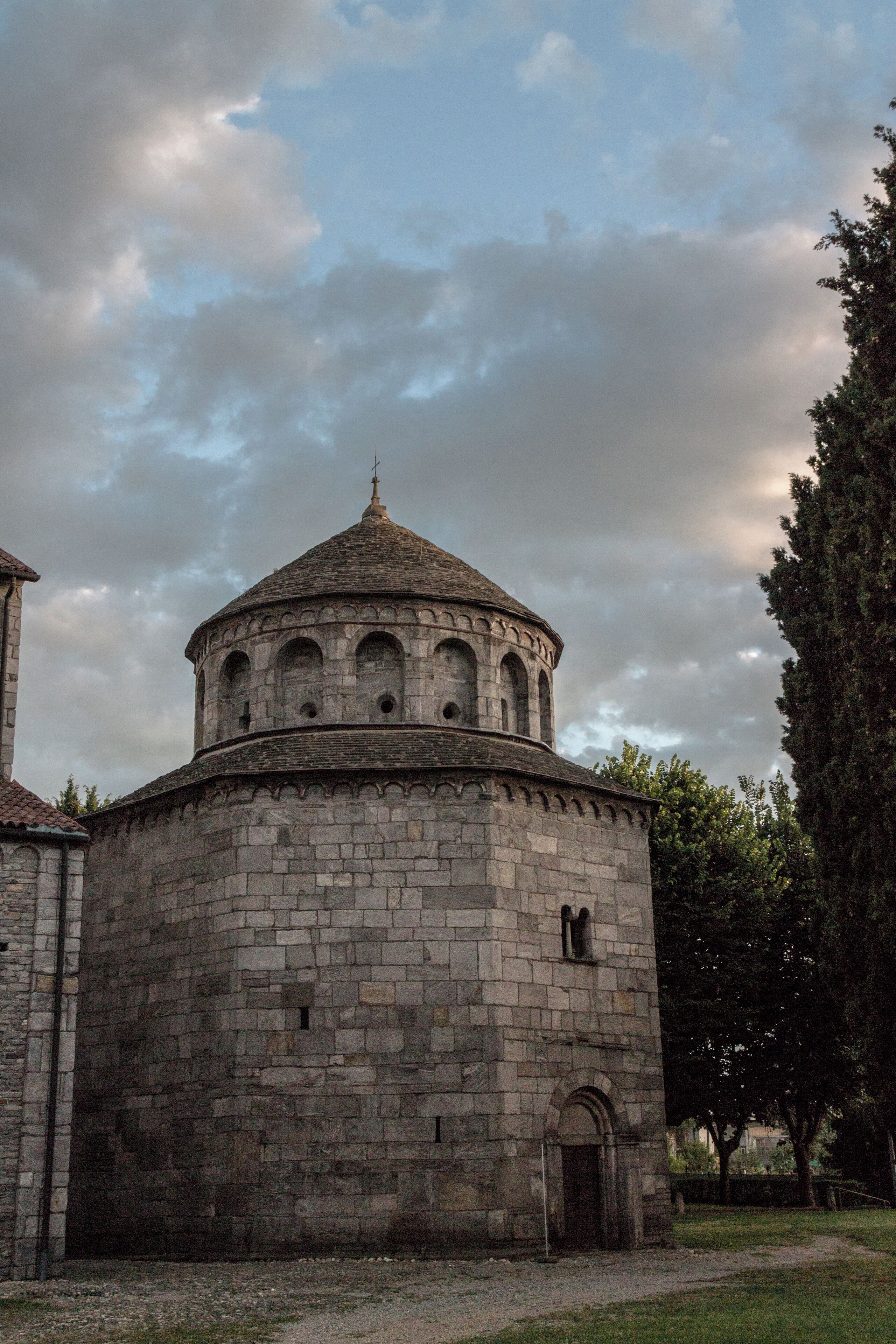 A stone church with a dome and arched windows.