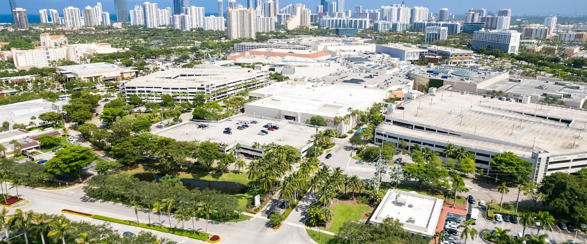 Aventura, Florida, USA - Aug 07, 2023: Aerial of Aventura Mall, with skyline of Sunny Isles Beach in the distance.