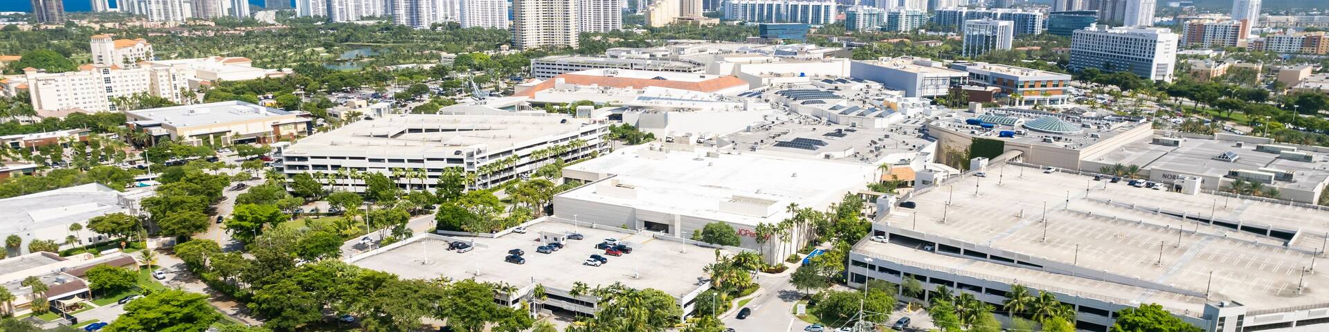 Aventura, Florida, USA - Aug 07, 2023: Aerial of Aventura Mall, with skyline of Sunny Isles Beach in the distance.