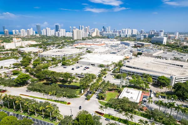 Aventura, Florida, USA - Aug 07, 2023: Aerial of Aventura Mall, with skyline of Sunny Isles Beach in the distance.