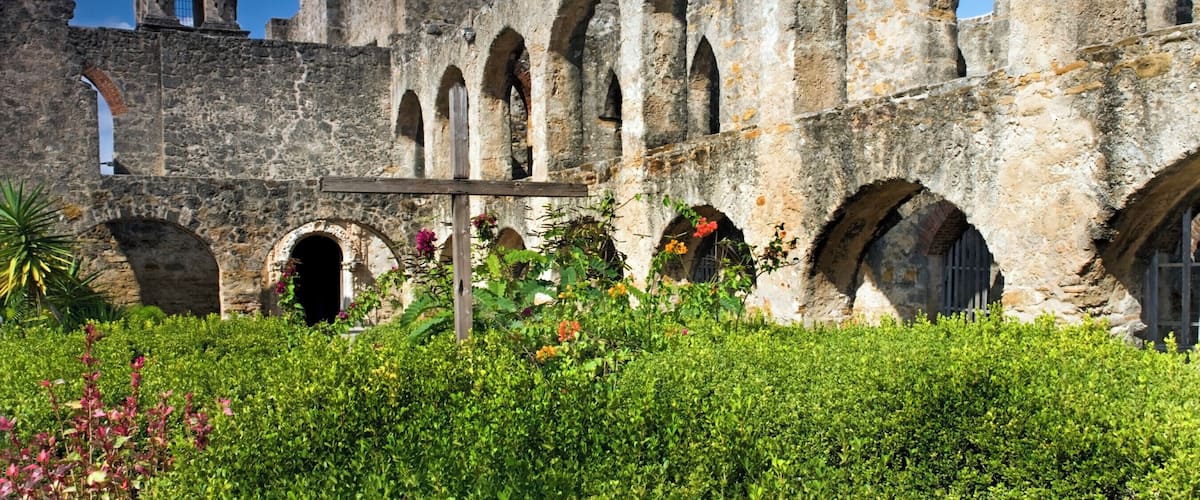 An ancient stone building with arches and a dome.
