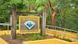 A sign for The Barnacle Historic State Park with a Florida Park Service emblem.