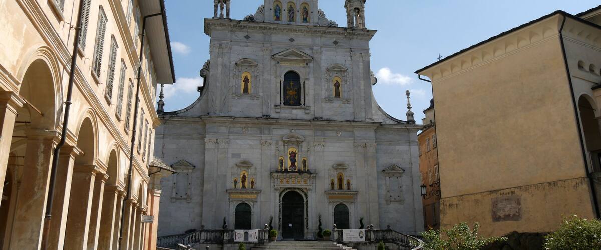 A grand church with a large dome and statues on the facade.