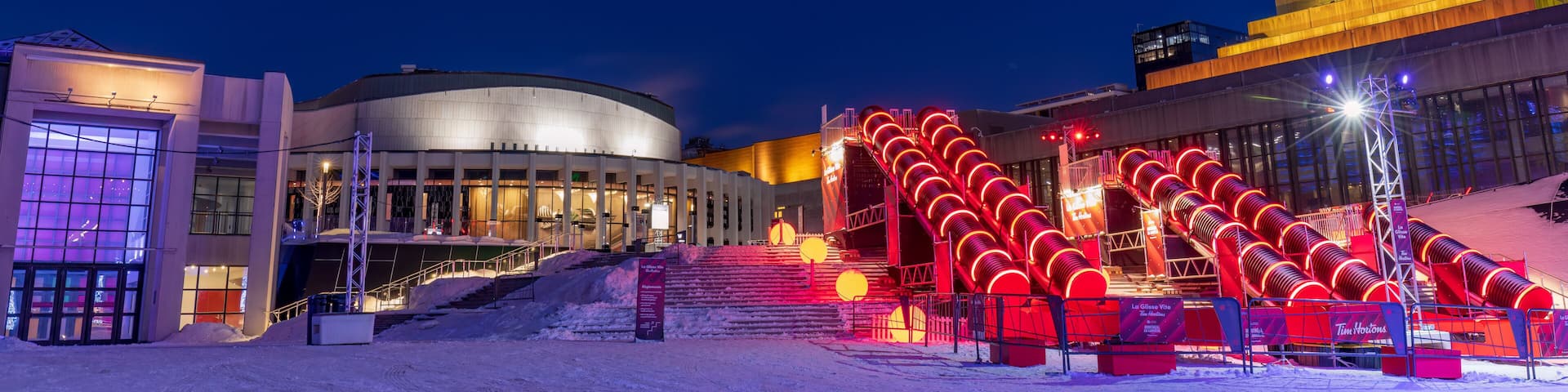 the Montreal en lumière festival attracts tourists to the Cartier Des Spectacles who can skate on the high skating rink and slide down the steps of Place Des Arts