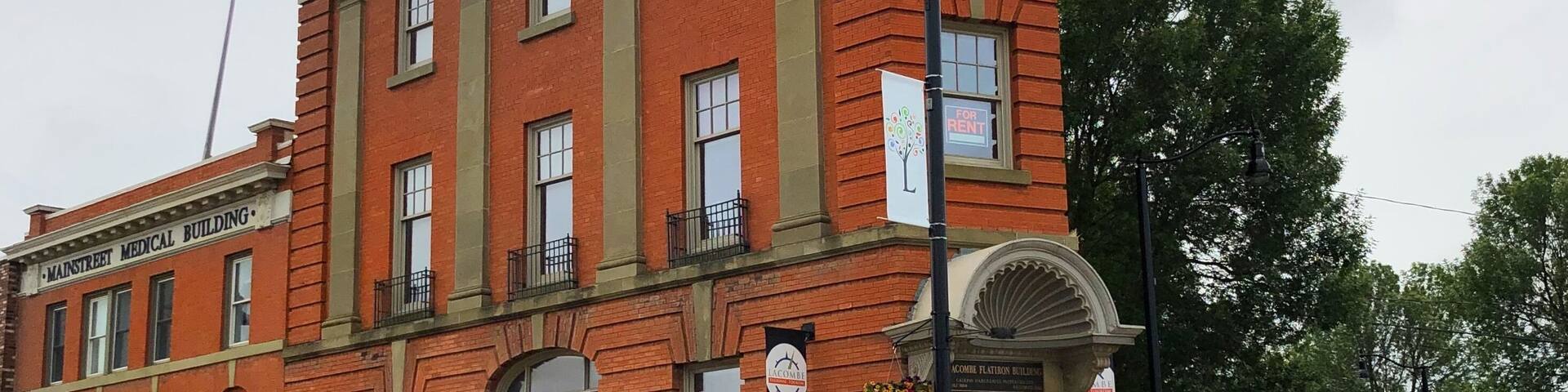 The Lacombe Flatiron Building was constructed in 1903-1904 by the Merchants Bank. Designed in the Beaux Arts tradition of classically-inspired architecture, it cost $30,000 to build in 1904. The design, however, set this structure apart; specific classical features includes the giant order pilasters or simulated columns which run through the second and third stories, a cornice along the top of the structure and scallop-shaped hood over the main entrance. The three-storey "flatiron" building is unique in the Town of Lacombe and the oldest of three structures built in western Canada. (July 2019)
#Trovember