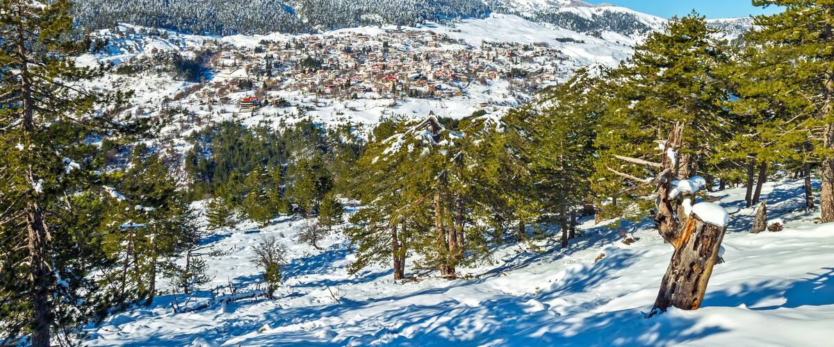 A snow-covered mountain range with a town nestled in the valley.