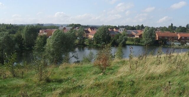 New houses by a pool on the Lunt. A new development on the Lunt close by the Black Country Route near to Bilston.