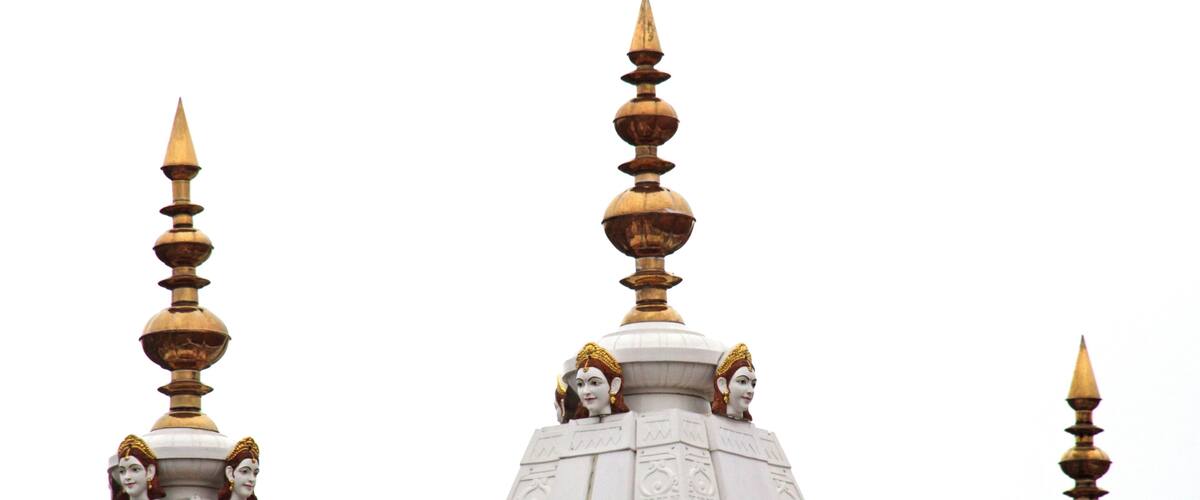 A temple with ornate spires and golden finials.