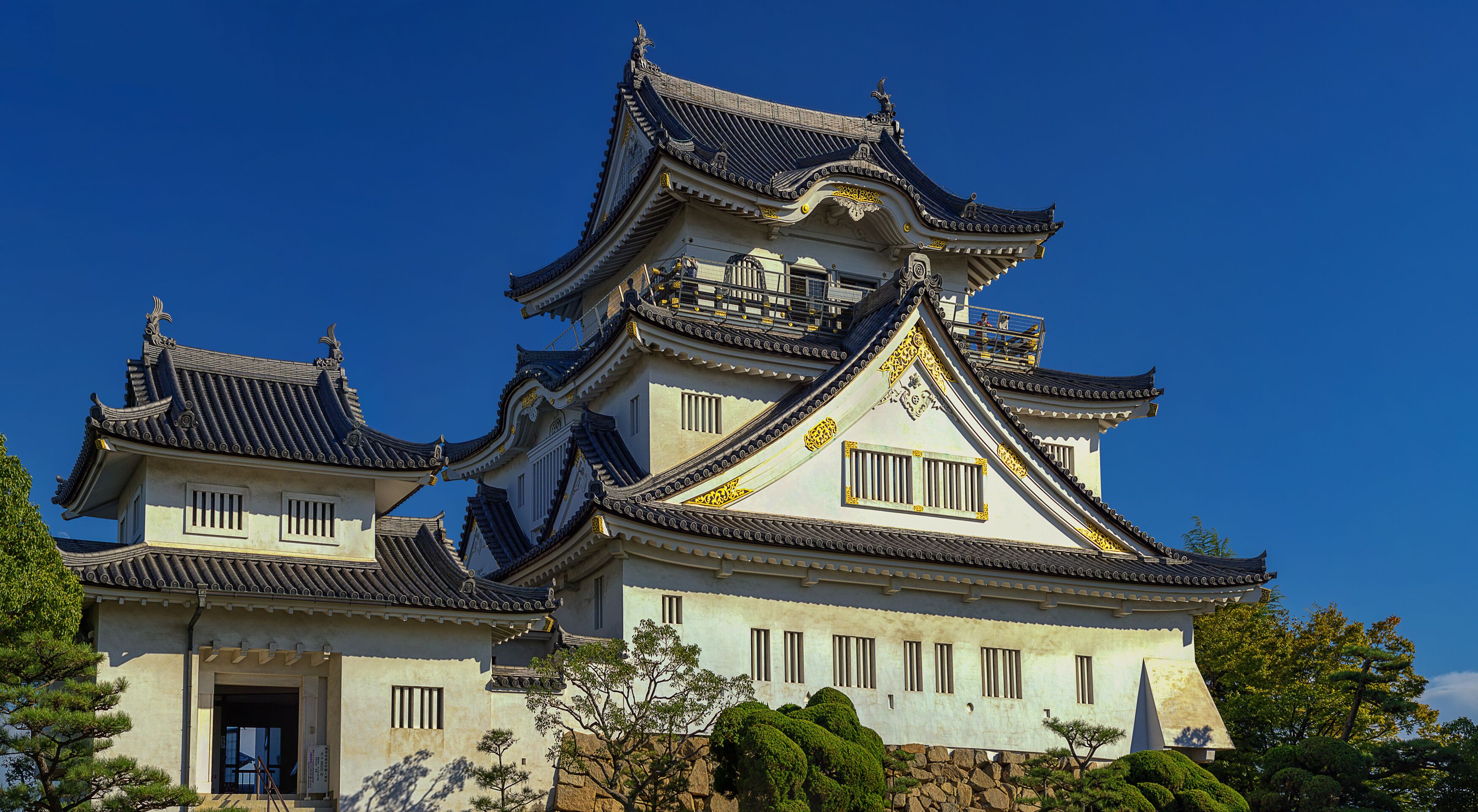 A traditional Japanese castle with multiple tiers and ornate roofs.