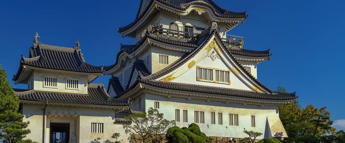 A traditional Japanese castle with multiple tiers and ornate roofs.