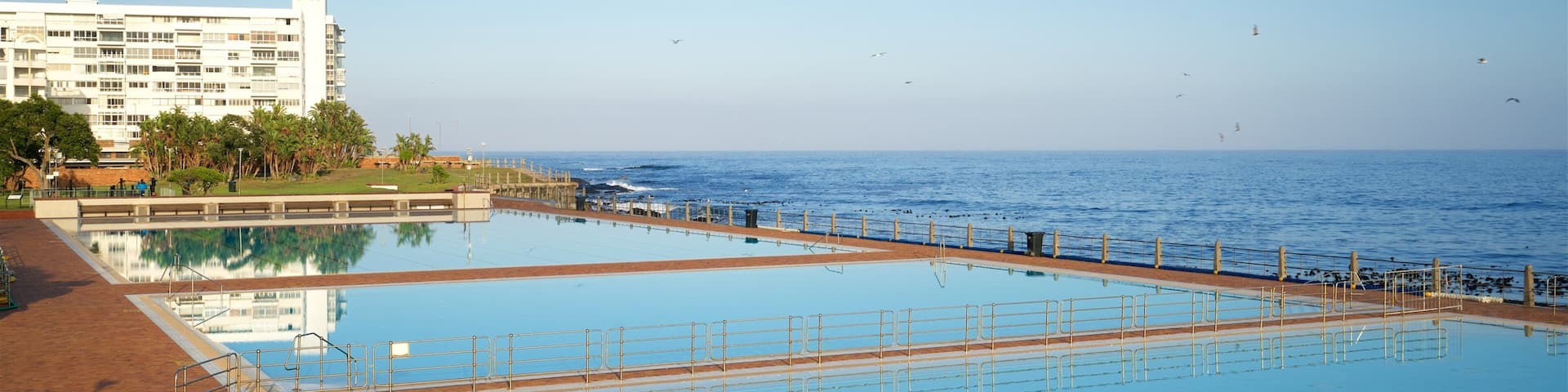 Sea Point Swimming Pool which includes general coastal views, a pool and a coastal town