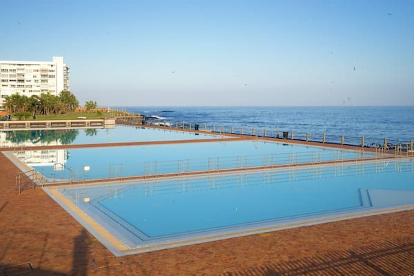 Sea Point Swimming Pool which includes general coastal views, a pool and a coastal town
