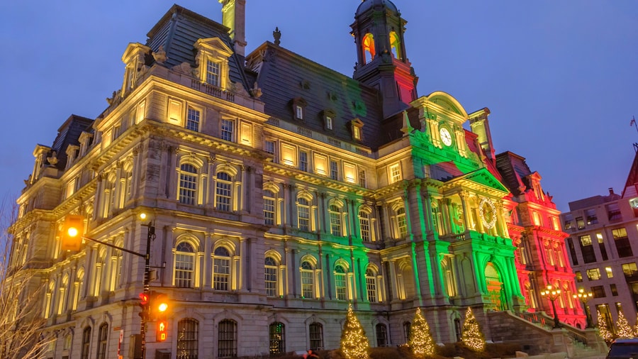 Scenic beautiful view City Hall of Montreal illuminated by colorful light. Depressive winter look government building in center of the largest megapolis city of Quebec in Canada