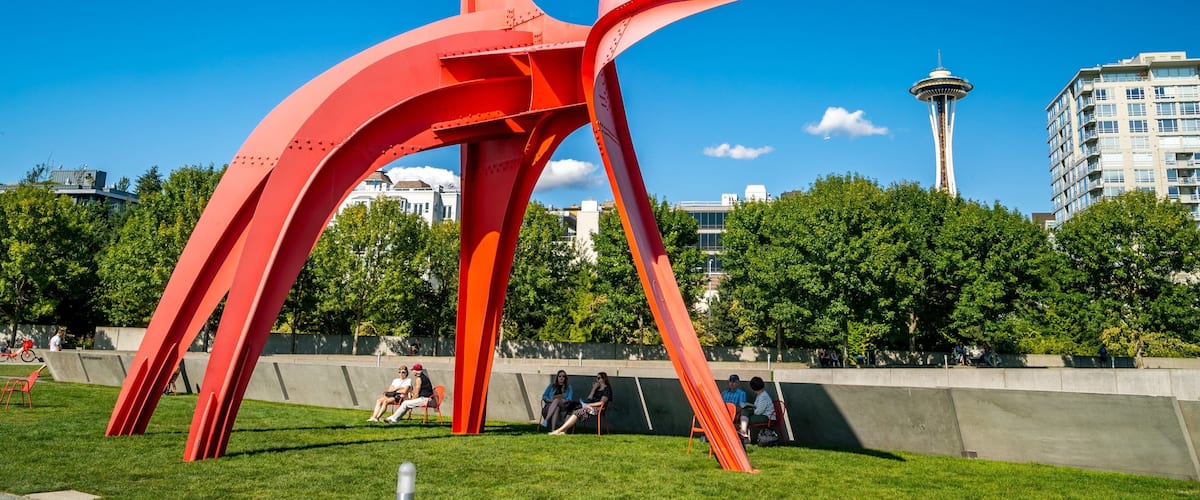 Olympic Sculpture Park featuring outdoor art and a park as well as a small group of people