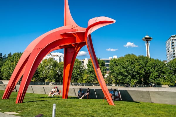 Olympic Sculpture Park featuring outdoor art and a park as well as a small group of people