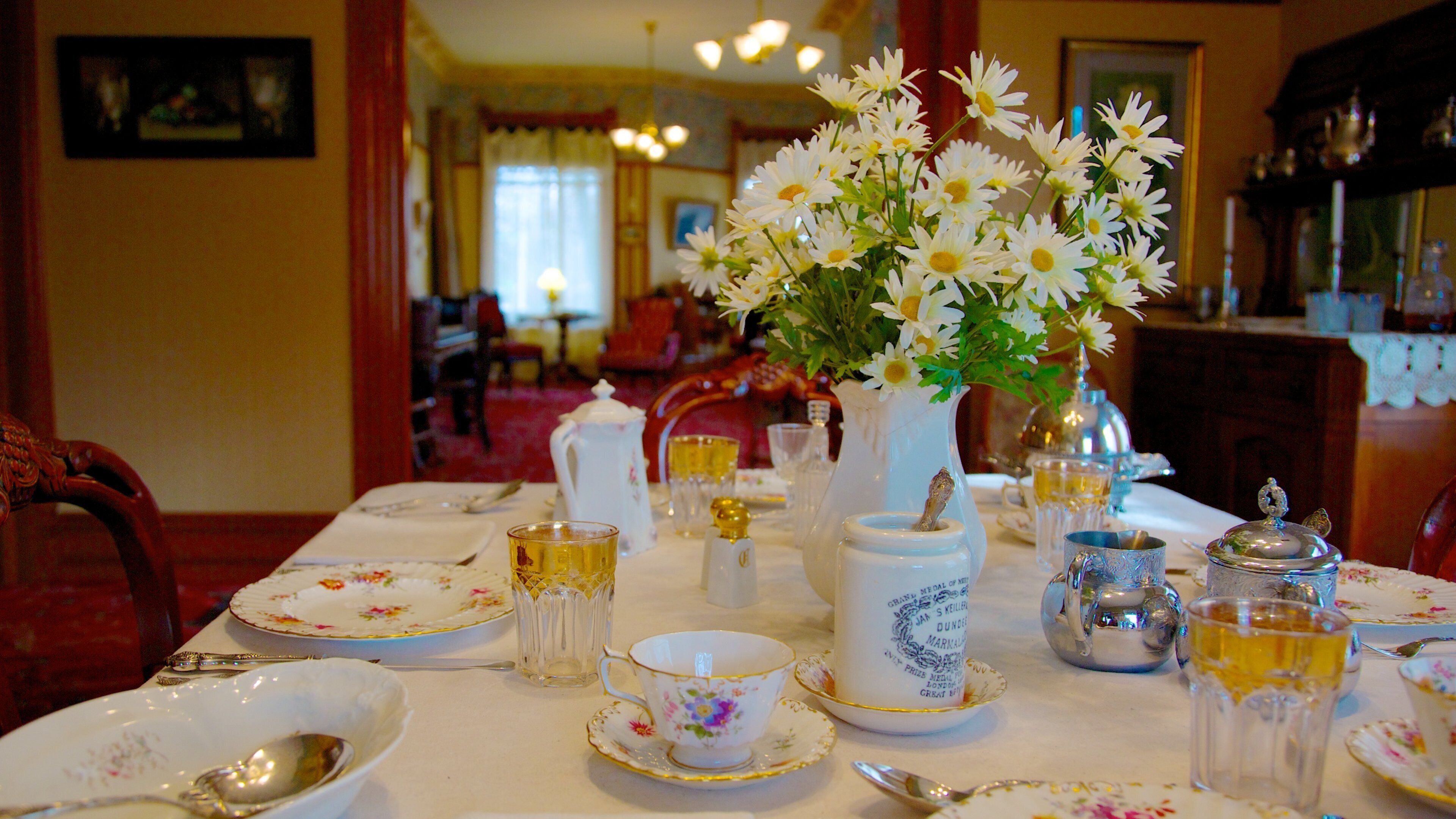 Explore the dining area of Ernest Hemingway Museum in Oak Park showcasing a classic table setting with flowers