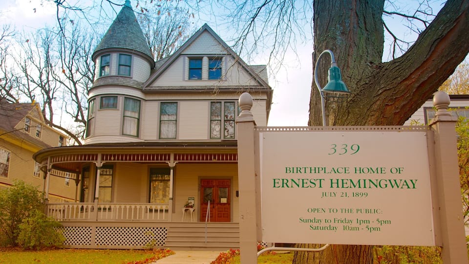 A historic house with a porch, a tower, and a sign indicating it is the birthplace of Ernest Hemingway.
