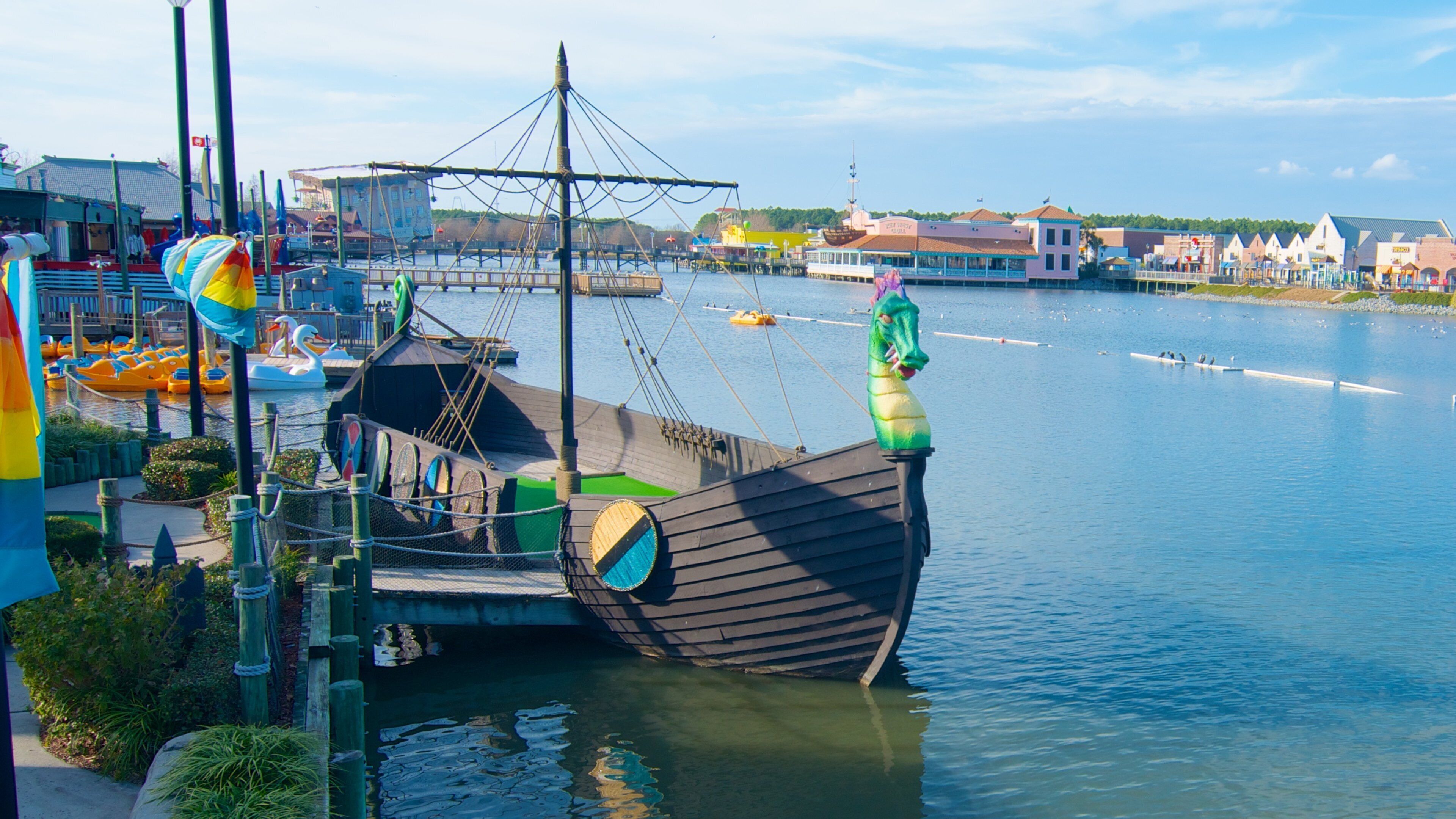 Explore Pavilion Nostalgia Park featuring a large pirate ship on the water in Myrtle Beach, South Carolina on a sunny day
