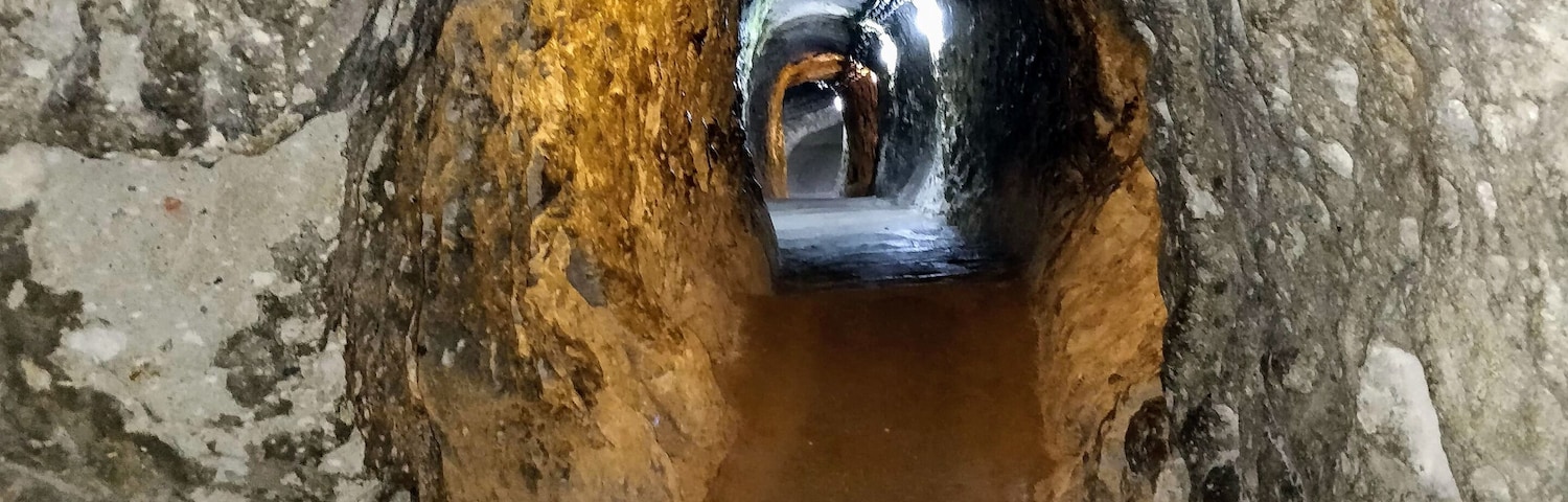 A manhole with a metal cover and a pipe extending from it.