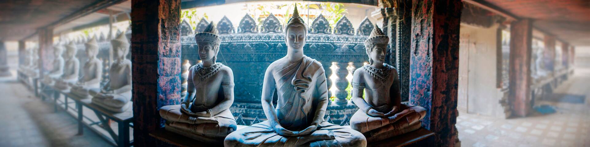 Buddha statues meditate in Wat Sa Kamphaeng Yai, Sisaket, Thailand. Wide-angle photo with the atmosphere of concentration.