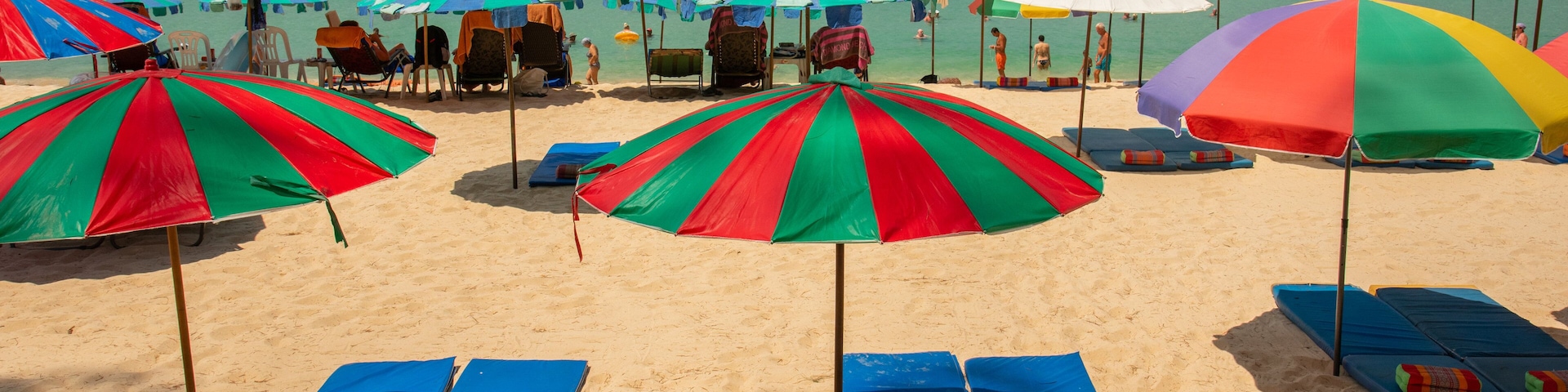 Surin which includes general coastal views and a sandy beach