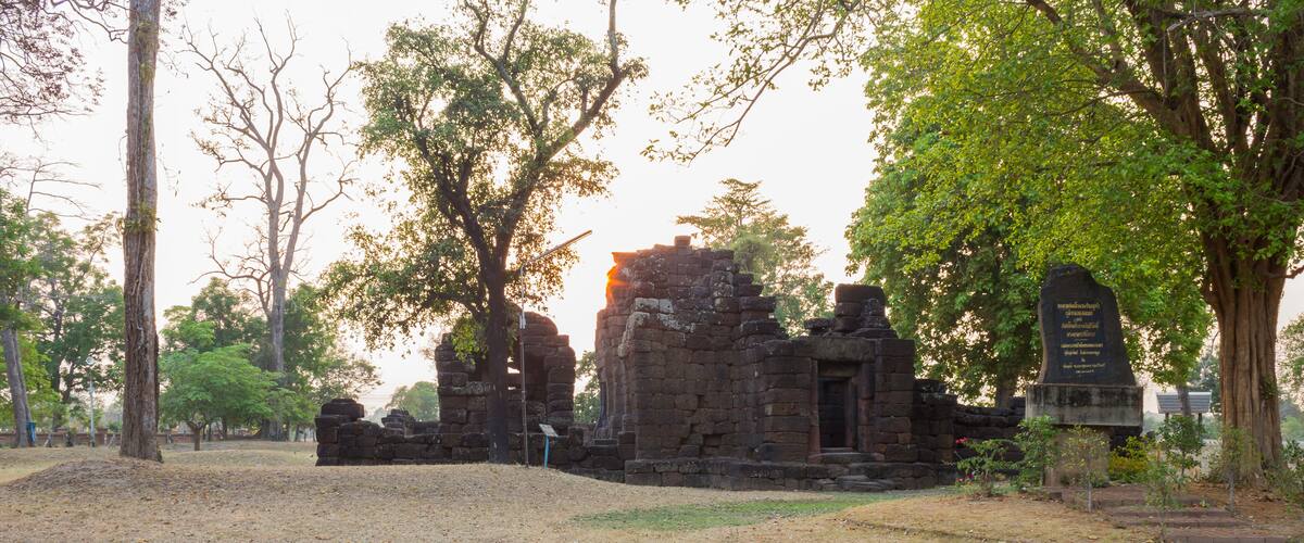 A stone temple surrounded by trees.