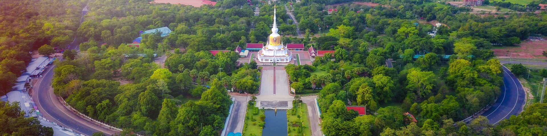 Aerial view of Phra That Nadoon or Wat Na Dun Pagoda at sunrise, Beautiful landmark and famous holy Buddha place in Maha Sarakham, Thailand.