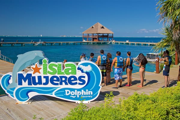 Dolphin Discovery featuring general coastal views and signage as well as a small group of people