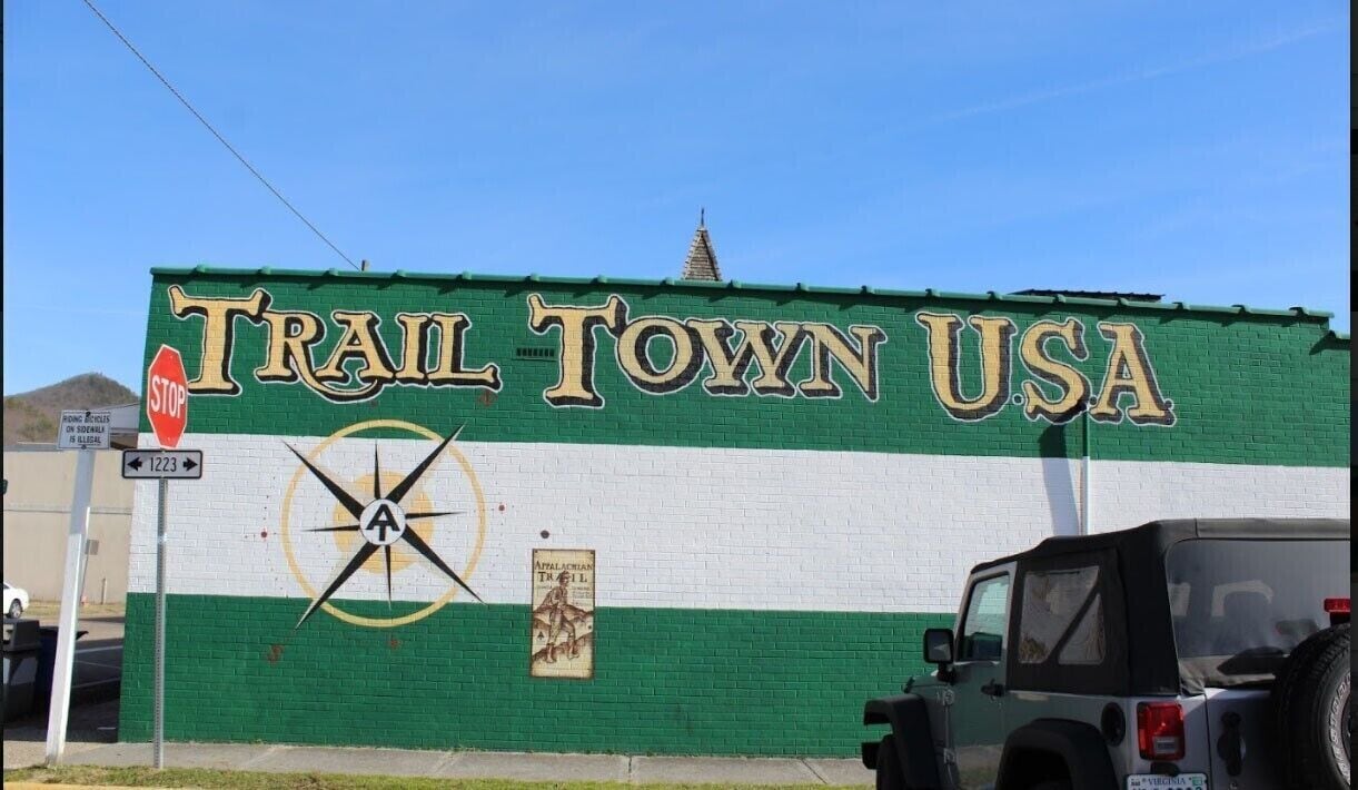 This image of a mural was taken in downtown Damascus, VA. It depicts a compass rose with the Appalachian Trail logo in the center with words, in a very large font, that read “Trail Town USA. Damascus prides itself for being a crossroads of more than six trails and being a gateway to the Mount Rogers Recreation Area. There is a festival that takes place in spring in this town called Trail Days where various outdoor activities take place. The Appalachian mountains is a place where thousands of hiking trails are located, and hiking is a common activity done by residents with in these mountains, so having an entire town dedicated to the activity is almost to be expected.
#appalachianechoes