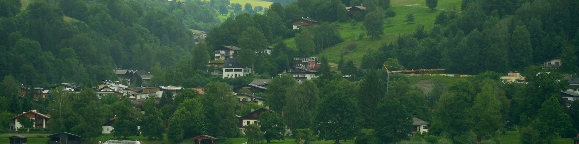 Zell am See - Pinzgau showing a lake or waterhole, a small town or village and mist or fog