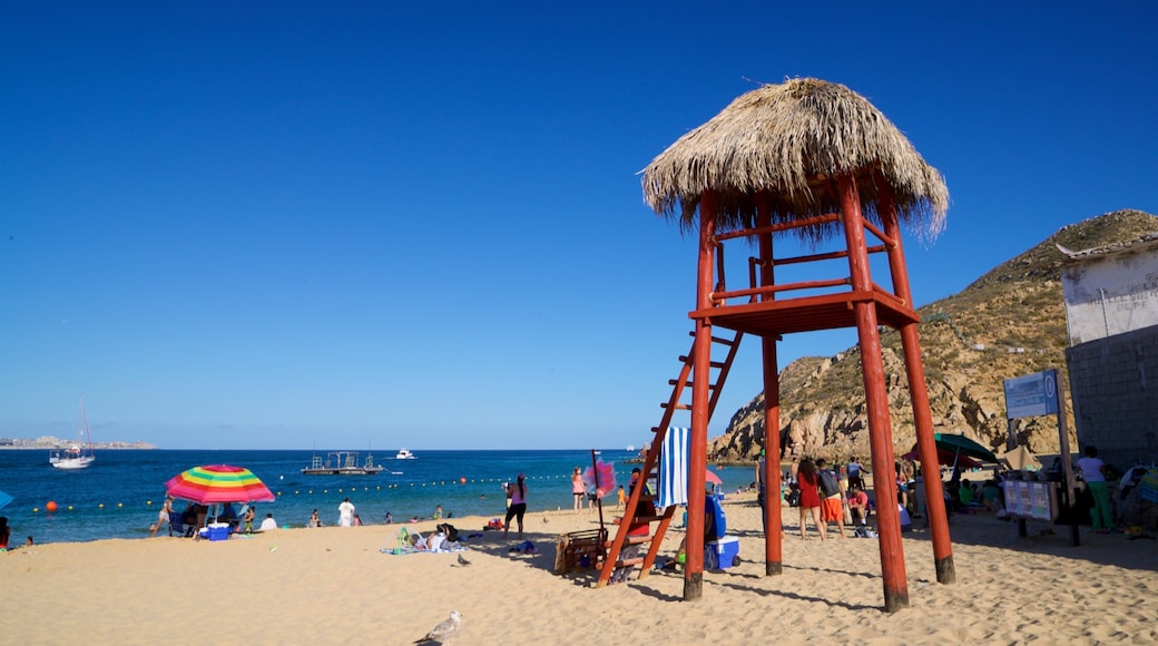 Cannery Beach showing a sandy beach and general coastal views as well as a small group of people