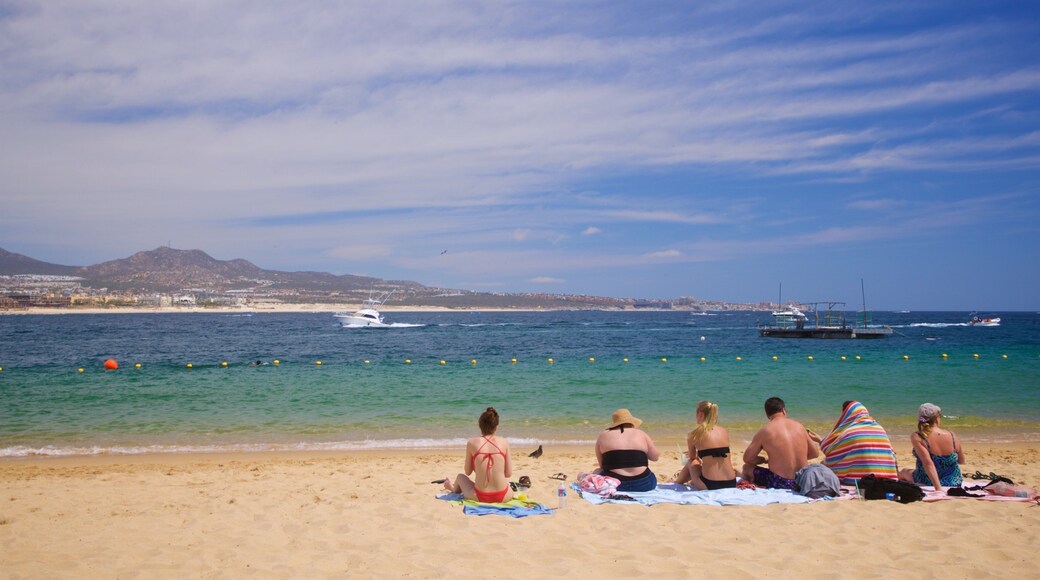 Cannery Beach which includes a sandy beach and general coastal views as well as a small group of people