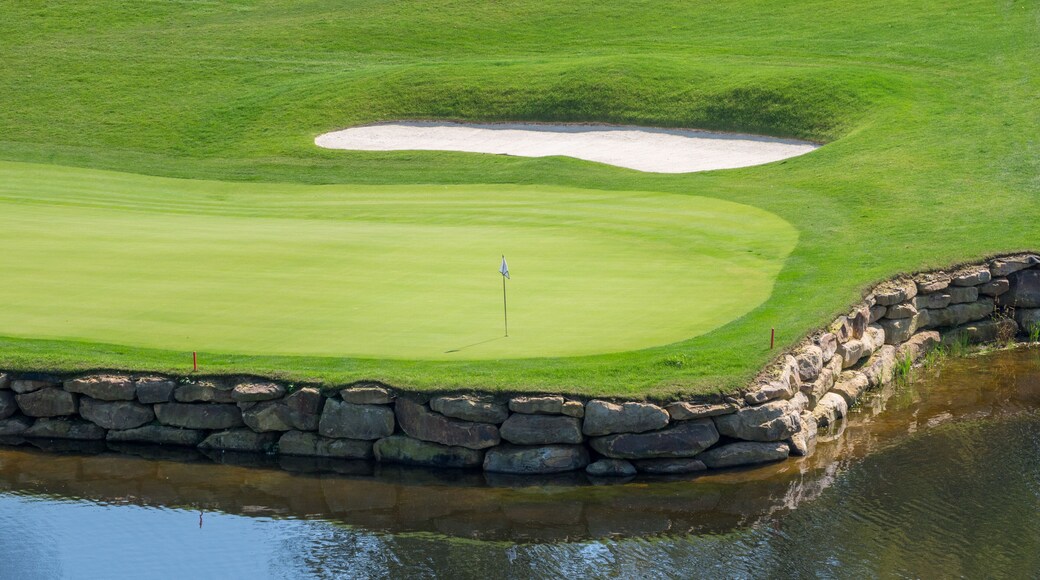 Challenging hole on luxury golf course with water and sand