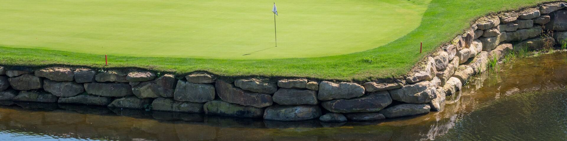 Challenging hole on luxury golf course with water and sand
