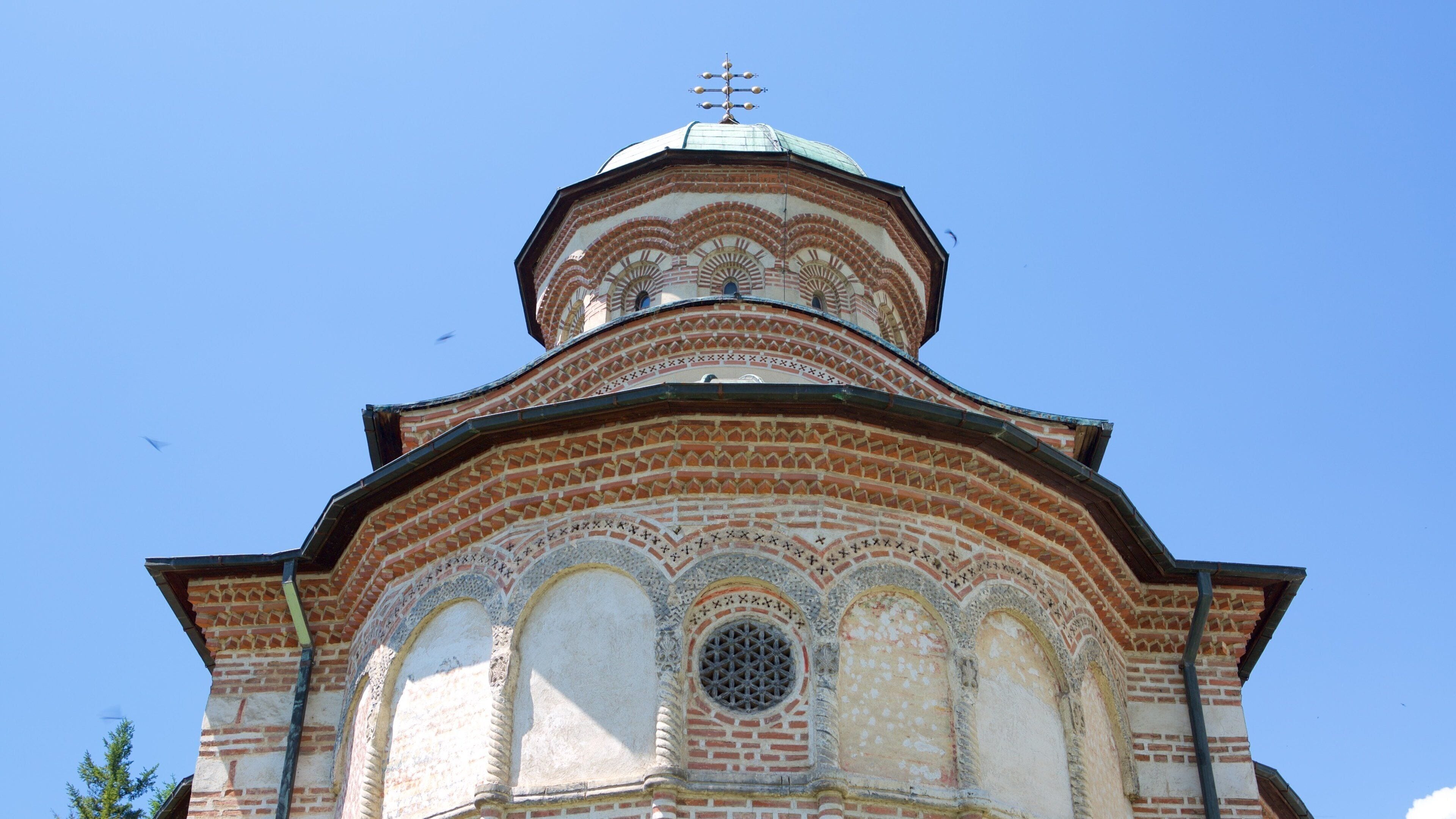 A domed building with intricate brickwork and a circular window.