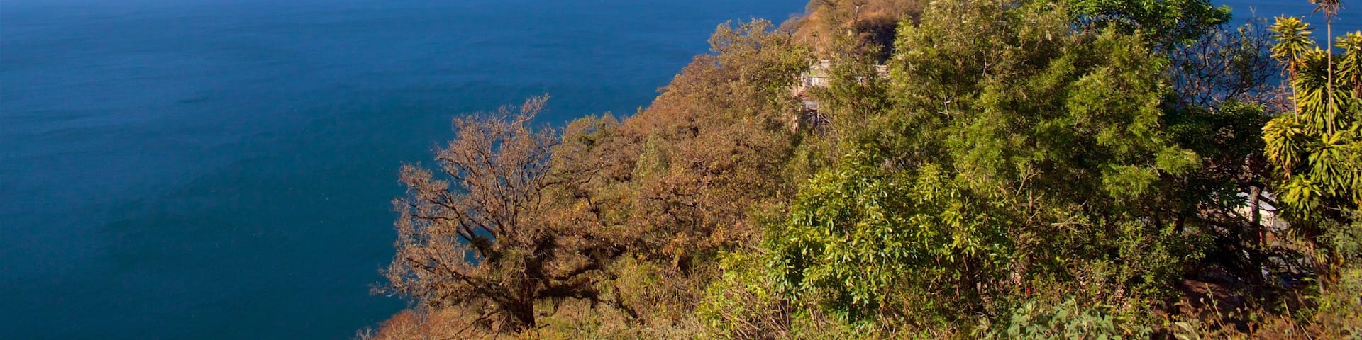 A coastal landscape with two prominent mountains and a body of water.