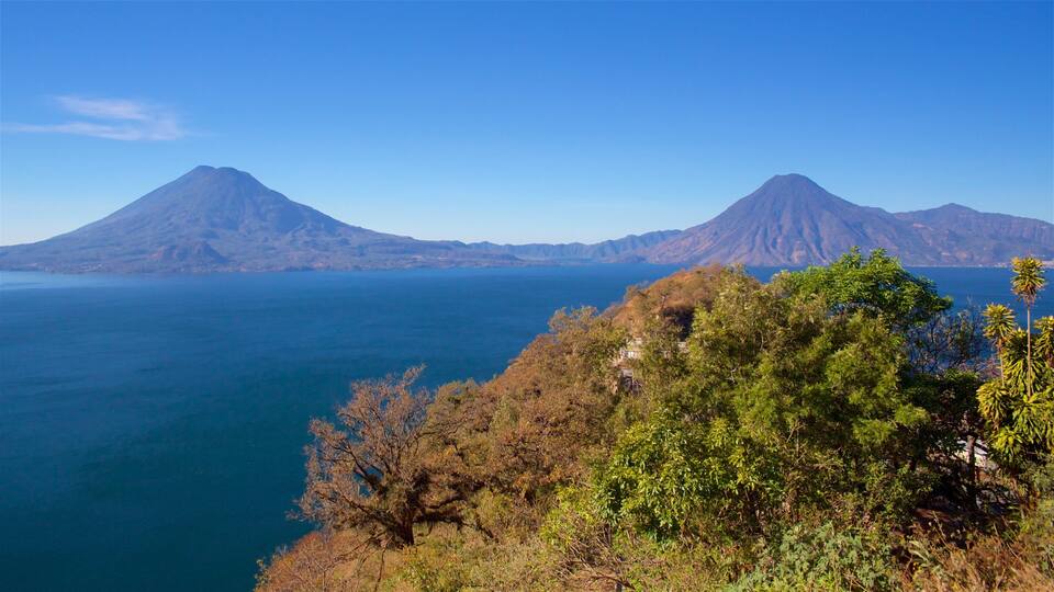 A coastal landscape with two prominent mountains and a body of water.