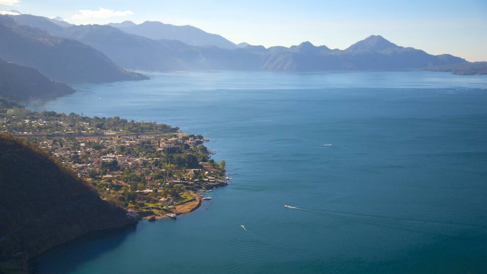 A coastal town with mountains in the background.