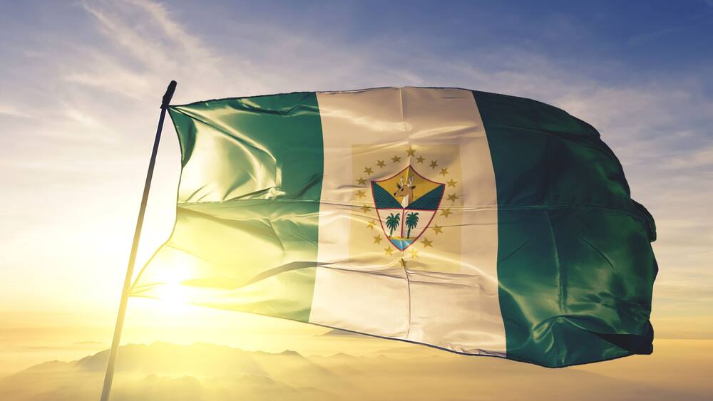 Suchitepequez department of Guatemala flag waving on the top sunrise mist fog
