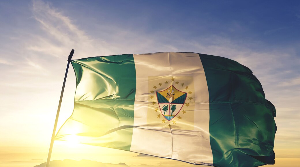 Suchitepequez department of Guatemala flag waving on the top sunrise mist fog