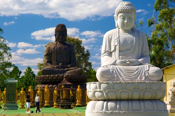 Buddhist Temple which includes a statue or sculpture, a temple or place of worship and religious aspects