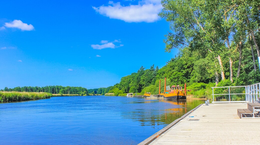 Beautiful natural landscape panorama jetty boat Oste river water Germany.