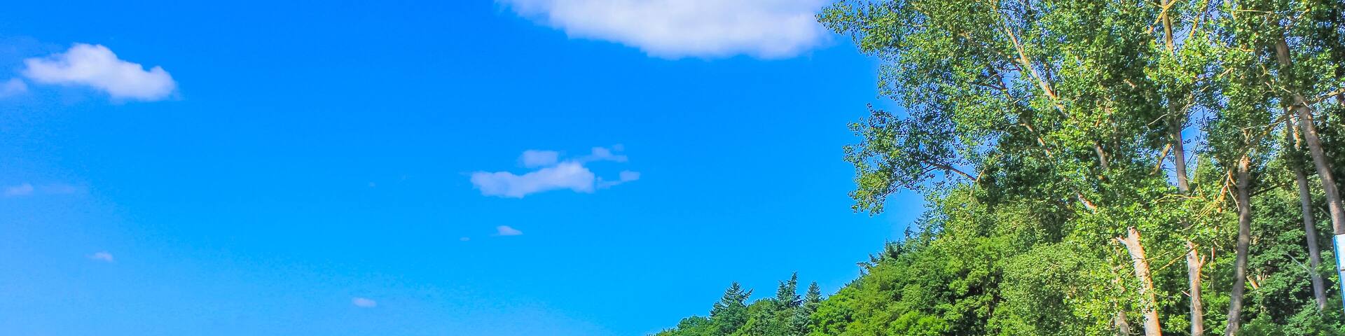 Beautiful natural landscape panorama jetty boat Oste river water Germany.