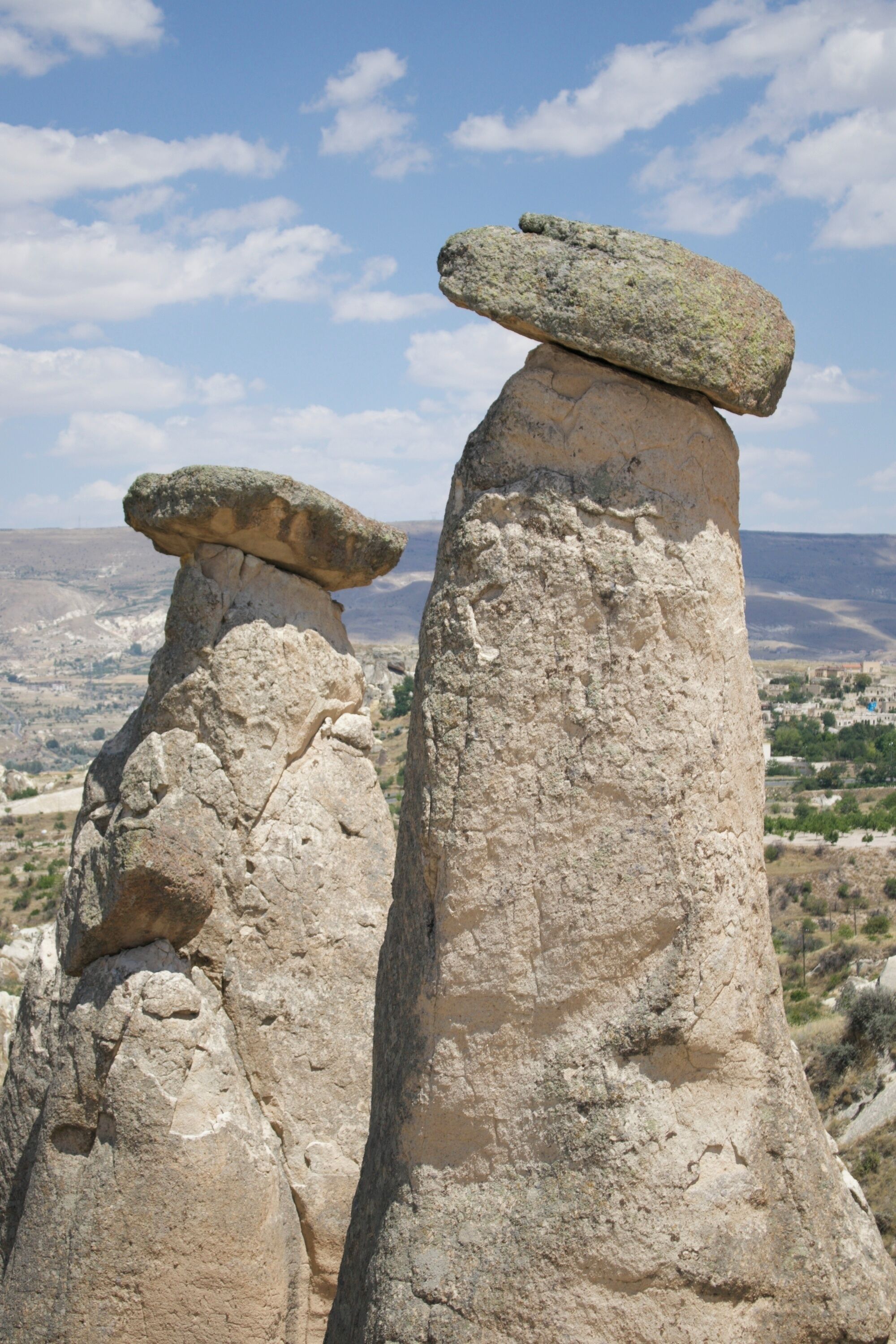 Two large rock formations with a clear sky in the background.