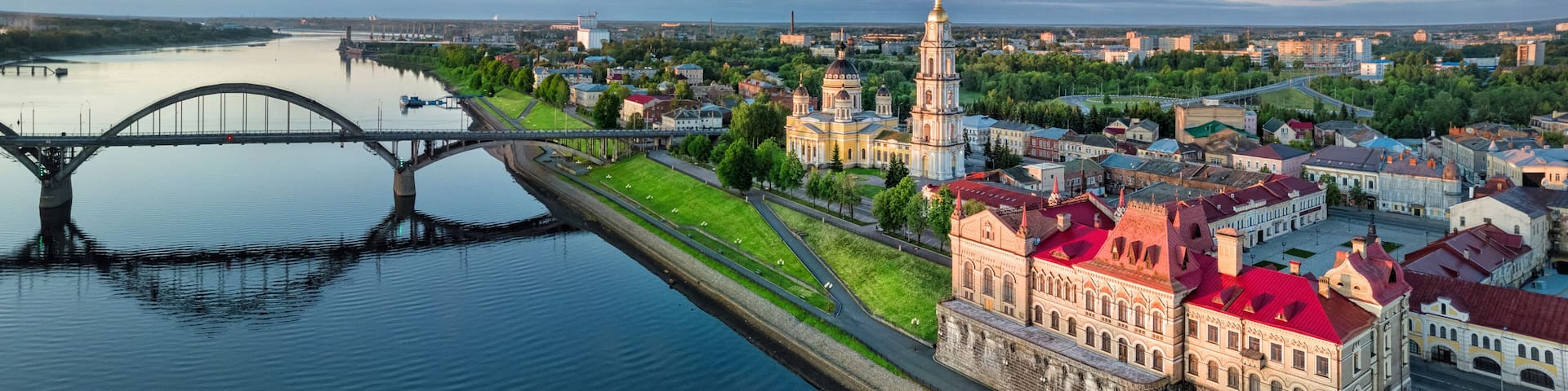 Aerial cityscape of Rybinsk: Volga river embankment, cathedral and bridge