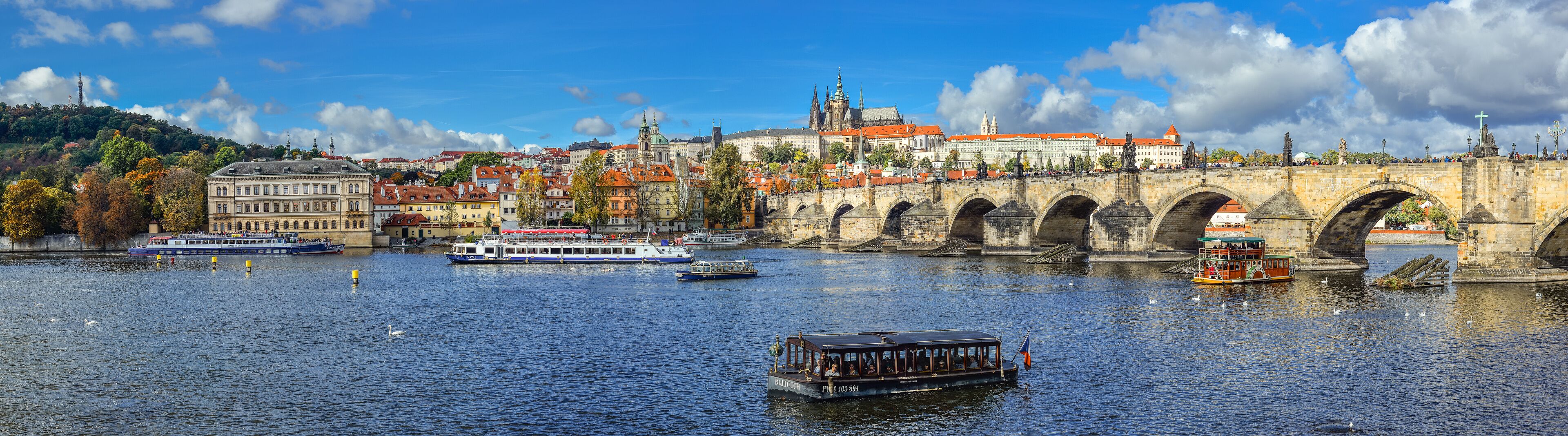 Prague, Czech Republic - October 10, 2017: Beautiful autumn river view on Vltava river, Charles Bridge and   Cathedral of Saints Vitus and Prague Castle , Czech Republic. Panorama.