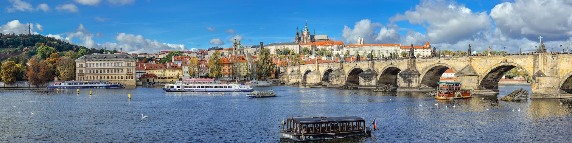 Prague, Czech Republic - October 10, 2017: Beautiful autumn river view on Vltava river, Charles Bridge and Cathedral of Saints Vitus and Prague Castle , Czech Republic. Panorama.